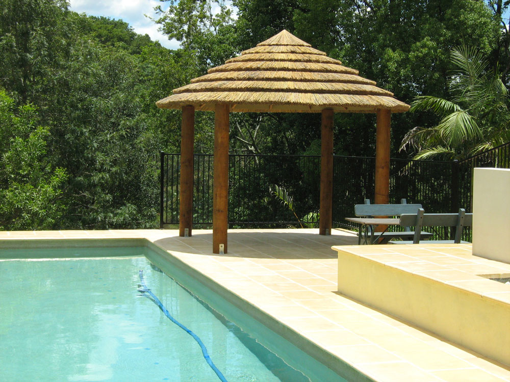 African thatch gazebo by a pool on the sunshine coast.