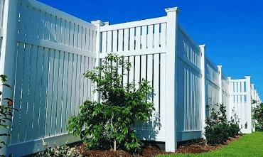 White PVC Fencing with blue Sunshine Coast skies in the background.